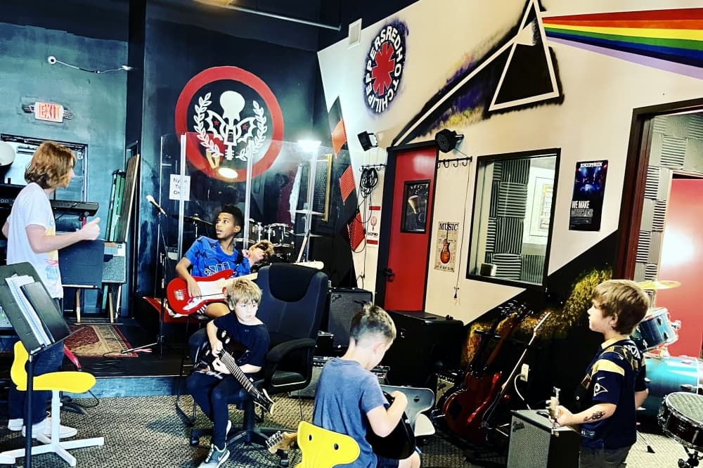 Campers play instruments during a School of Rock summer camp.