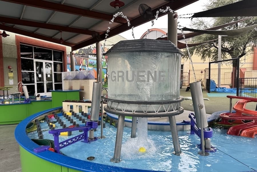 The outdoor water table features New Braunfels landmarks such as the Gruene water tower and the Comal River's tube shoot. (Thalia Guzman/Community Impact)
