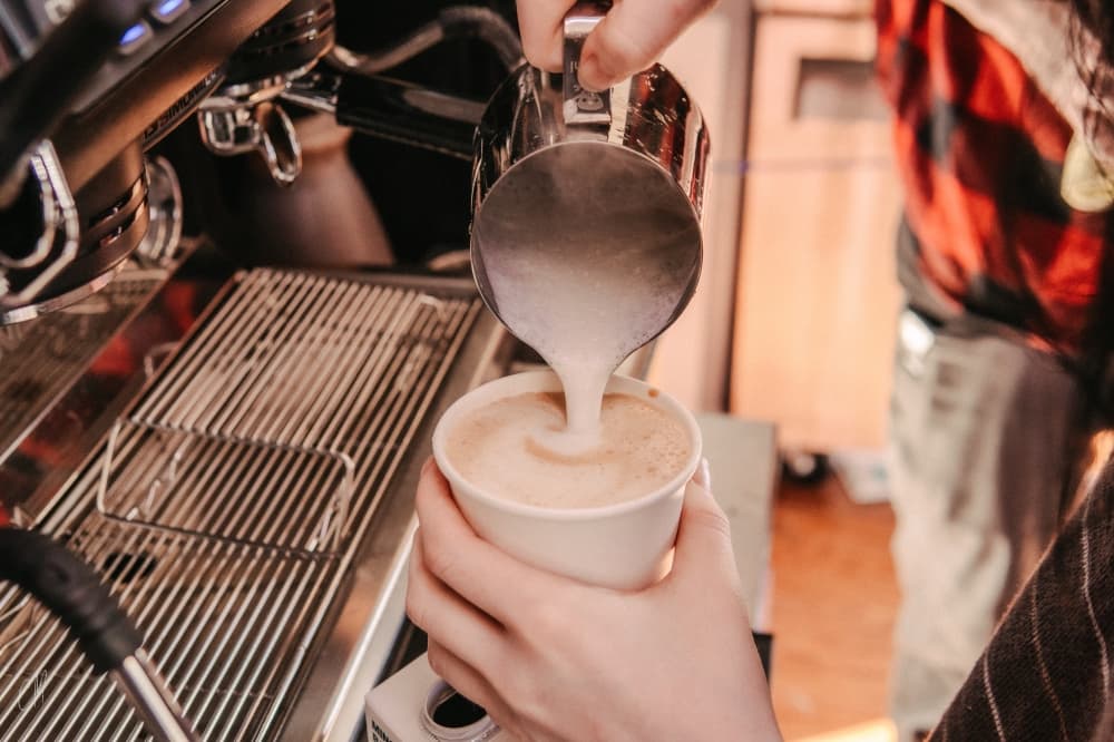 A close up photo of coffee being poured.