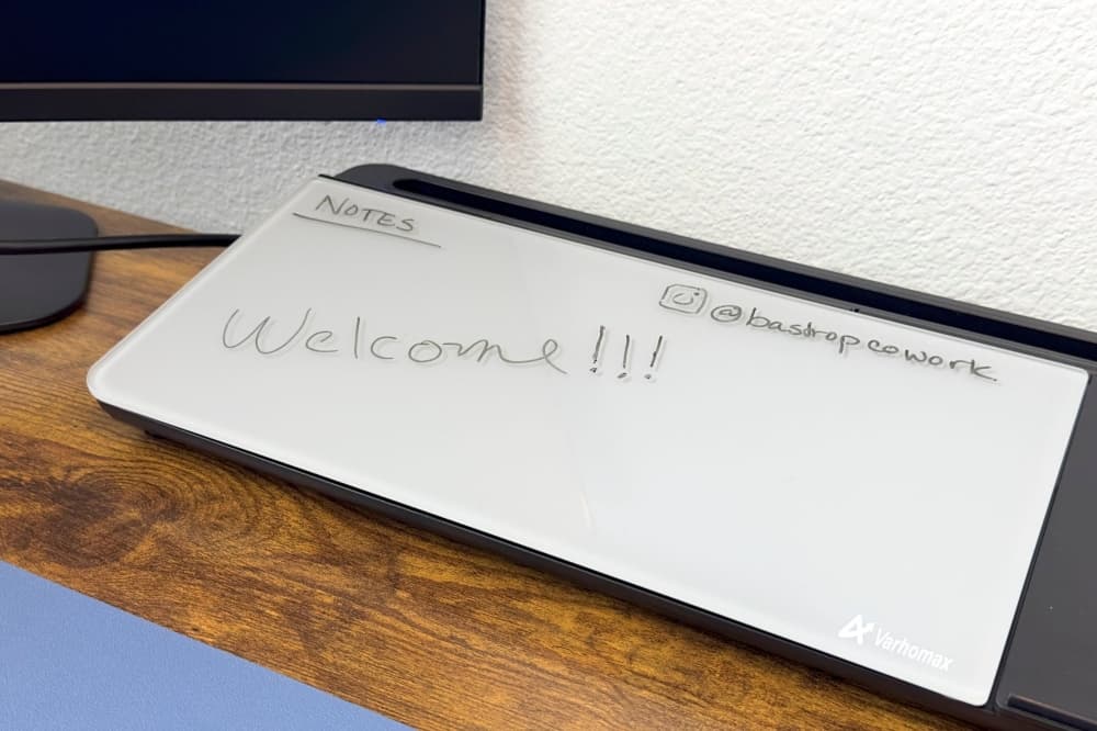 A whiteboard is shown on one of the desks, with words on it that read 