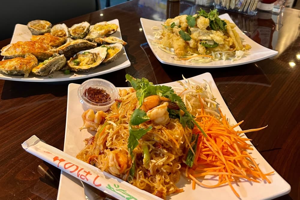 A photo of three different seafood dishes on plates