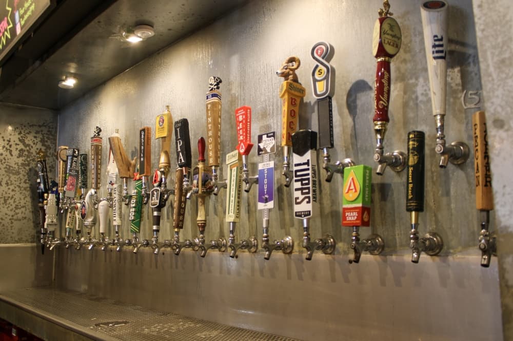 An image of the beer taps on the wall of the bar. 