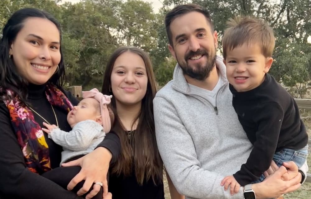 The Daltons pose for a photo with their teen daughter, toddler son and a baby.