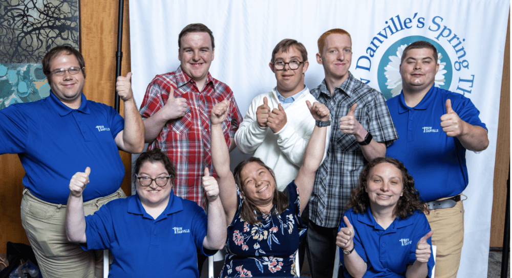A group of adults giving thumbs up