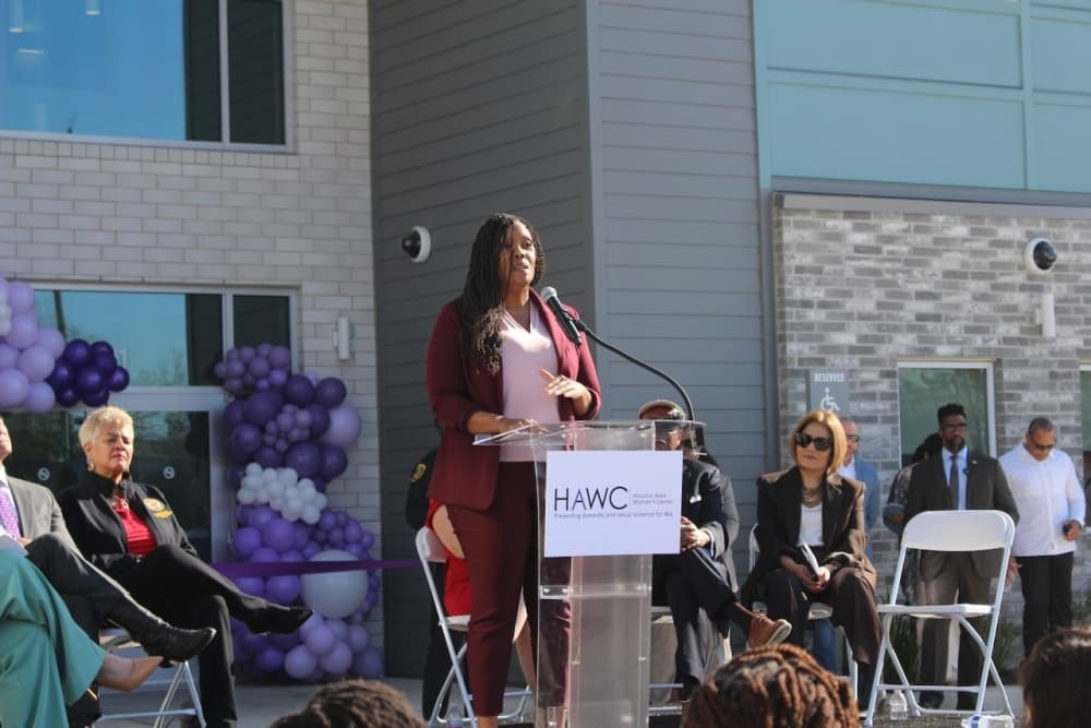 Board member Atika Abdur-Rahim standing at a podium.