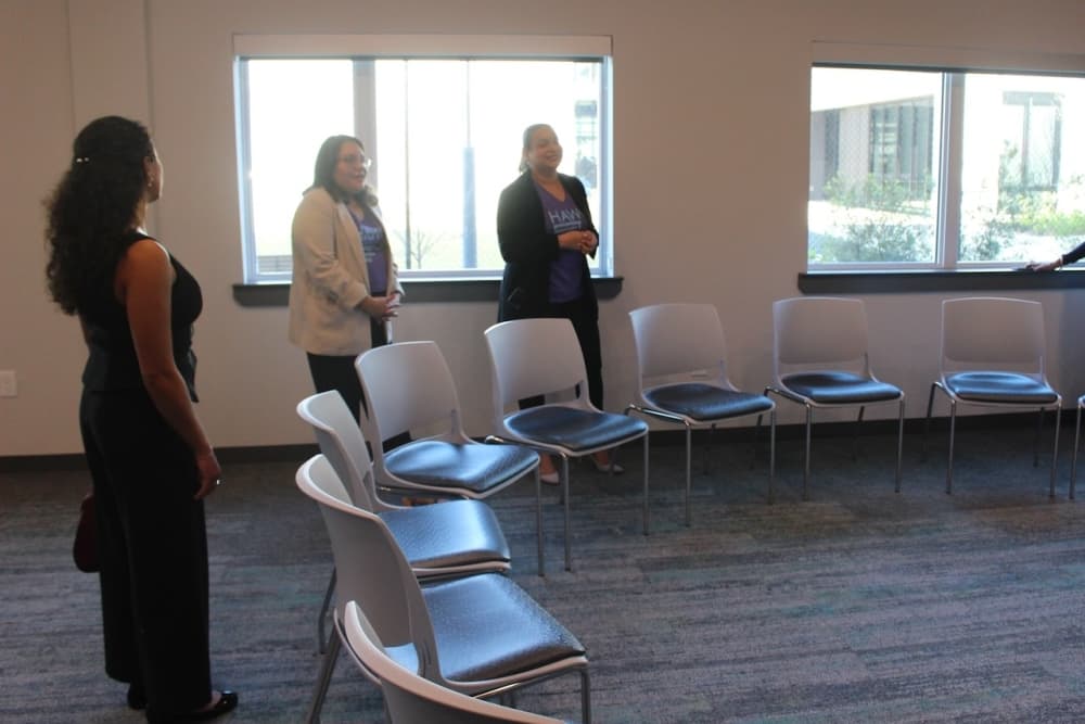 Harris County Judge Lina Hidalgo standing next to HAWC staff.