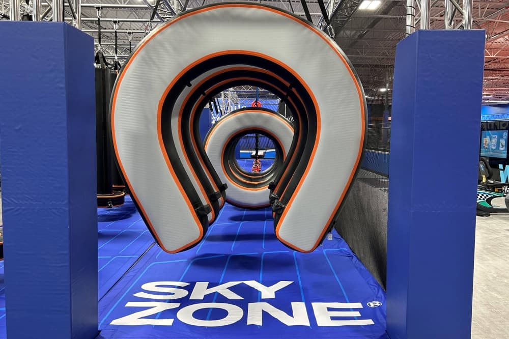 Padded elements of an obstacle course with Sky Zone branding. 