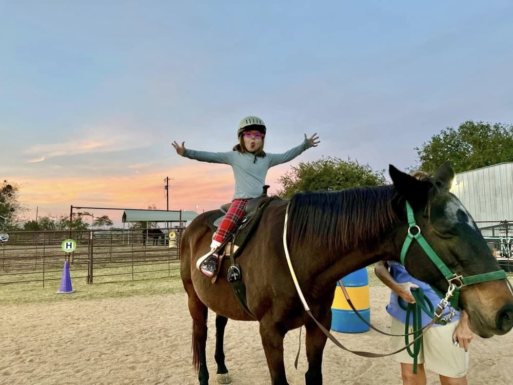 A photo of a student riding a horse. 