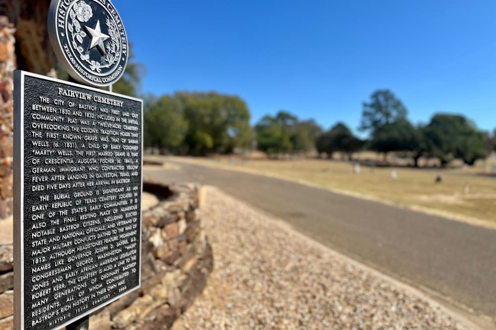 A view of the cemetery is in the background, with the Fairview Cemetery historic marker in the foreground.