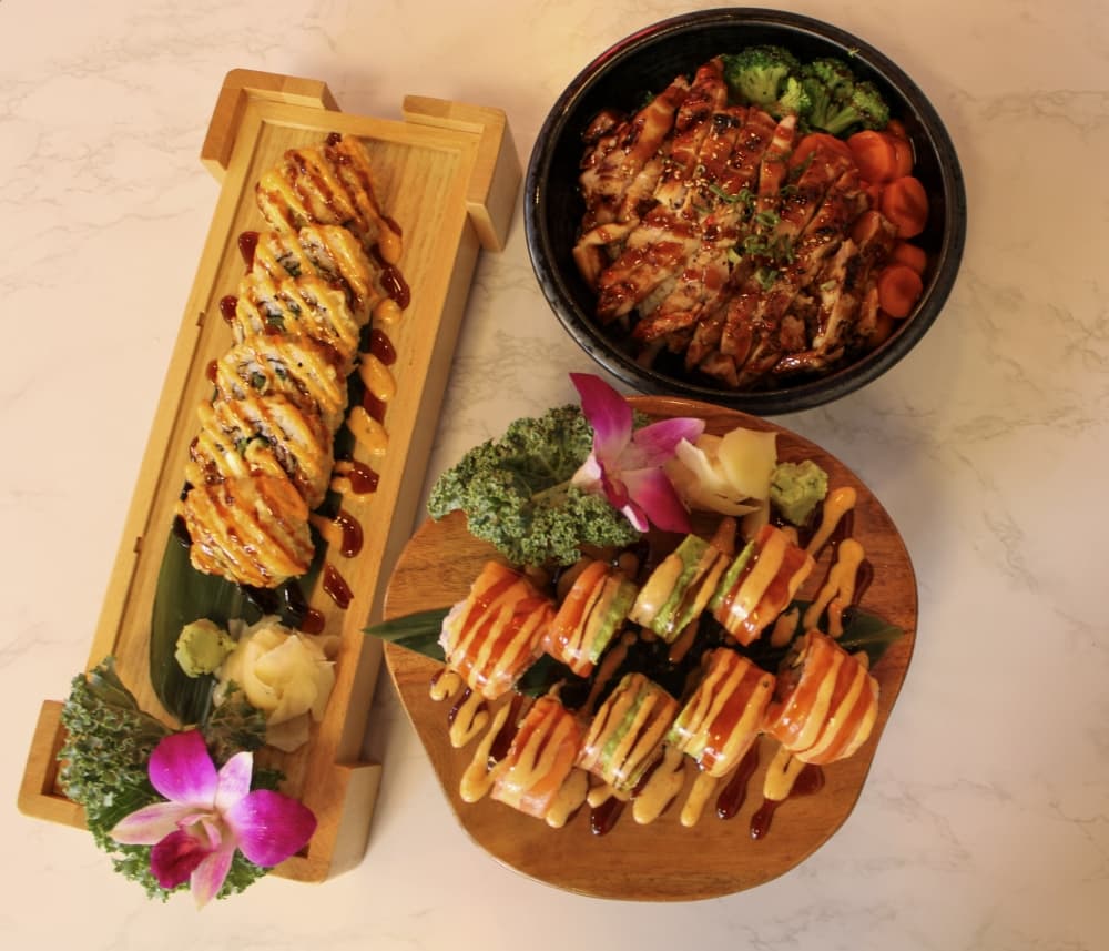 An image of two sushi rolls and a bowl. 