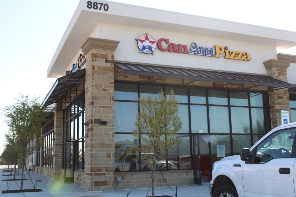 Exterior of a building with Can Am Pizza signage