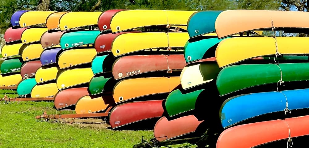 Stacks of kayaks are shown.