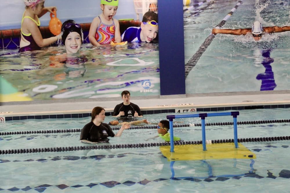 instructors with students in the pool 