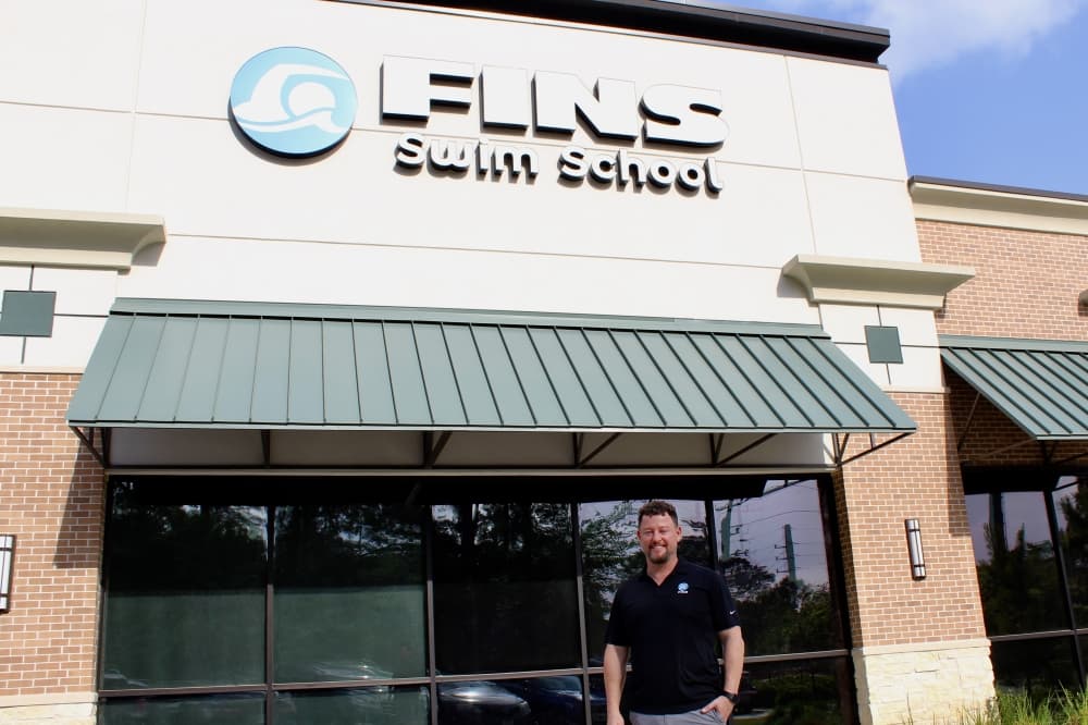 owner in front of building 