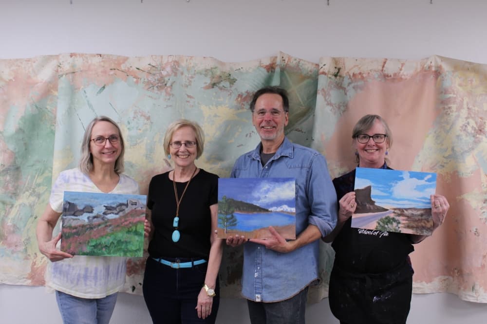Artists holding their painting at an art gallery in The Woodlands 
