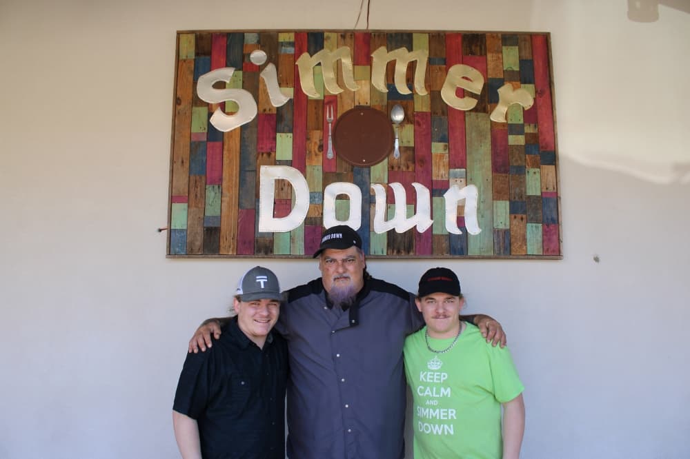Simmer Down Cafe owner Chris Marino (middle) poses with his two nephews who help run the cafe.