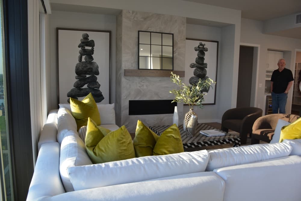 The living room of the penthouse opens into the dining and kitchen areas of the unit.