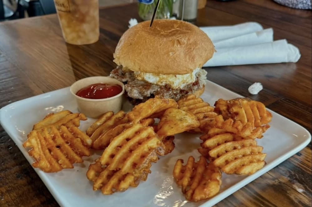 The breakfast. burger ($17.49) consists of a smash sausage, bacon, jam, hashbrowns, American Cheese, egg on a Brioche Bun. The burger also comes with waffle fries. (Courtesy breakfast.)