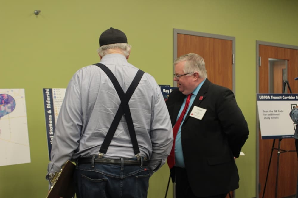 Project Manager Thomas Gray visits with community members during the April 23 public meeting. (Aubrey Vogel/Community Impact)