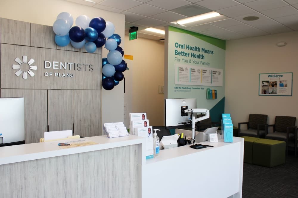 Front lobby of a dentists office with Dentists of Plano signage. 