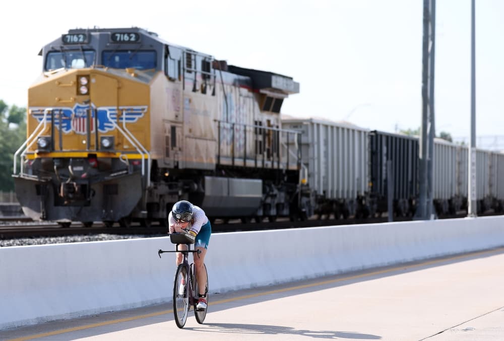 Biker races alongside a train
