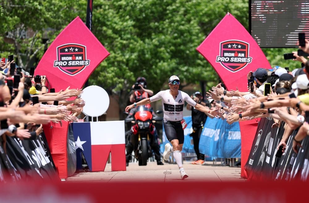 a runner high fives spectators