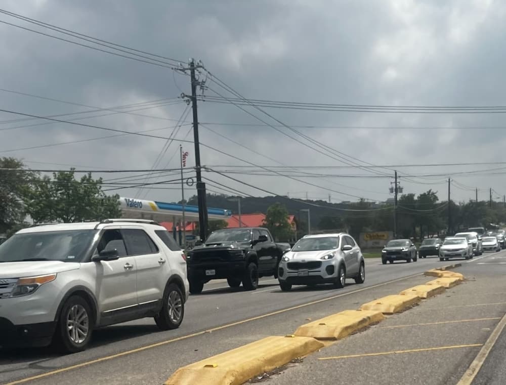 cars driving by raised medians
