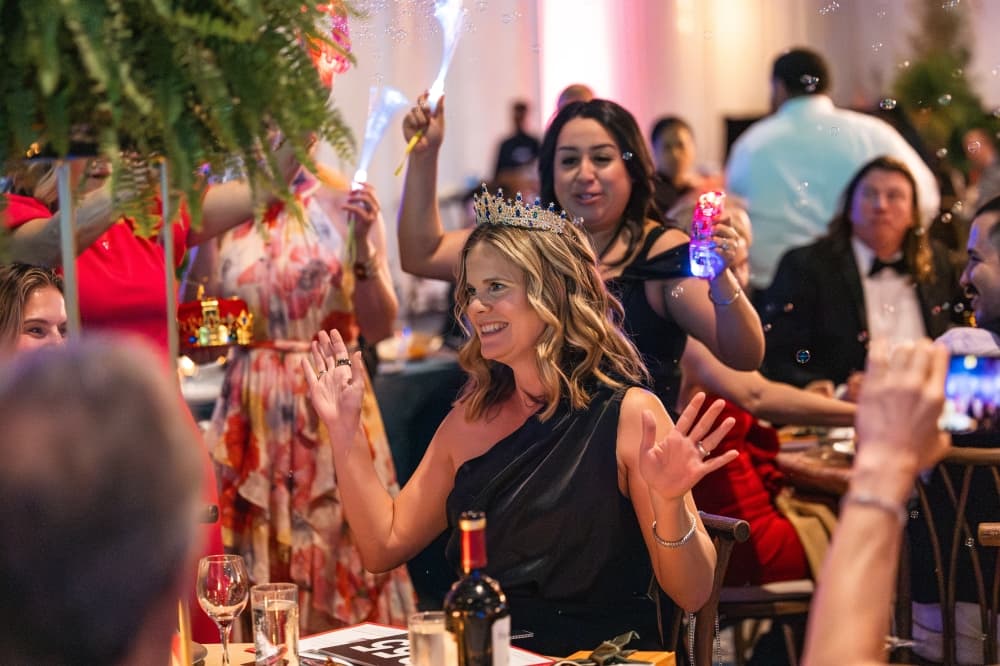 women celebrating at an aucion and gala