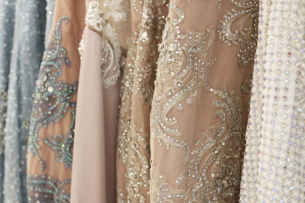 Close up of beaded dresses of varying colors. 