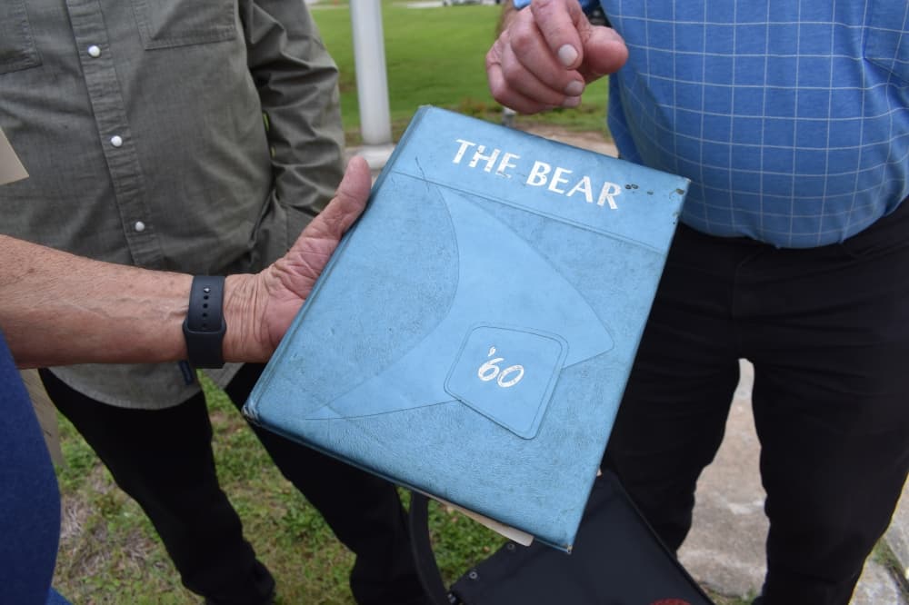 A former MISD students shows his Montgomery High School yearbook from 1960. (Julianna Washburn/Community Impact)
