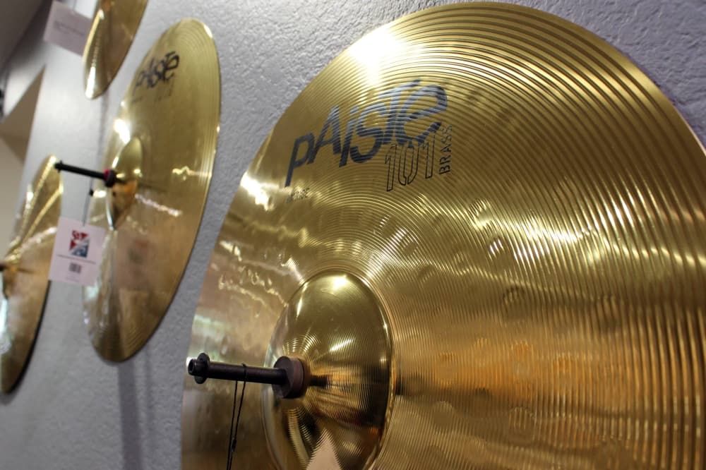 Drum cymbals hanging on a wall. 