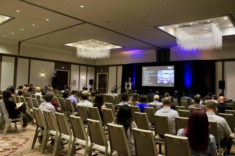 People sitting in a room watching a presentation
