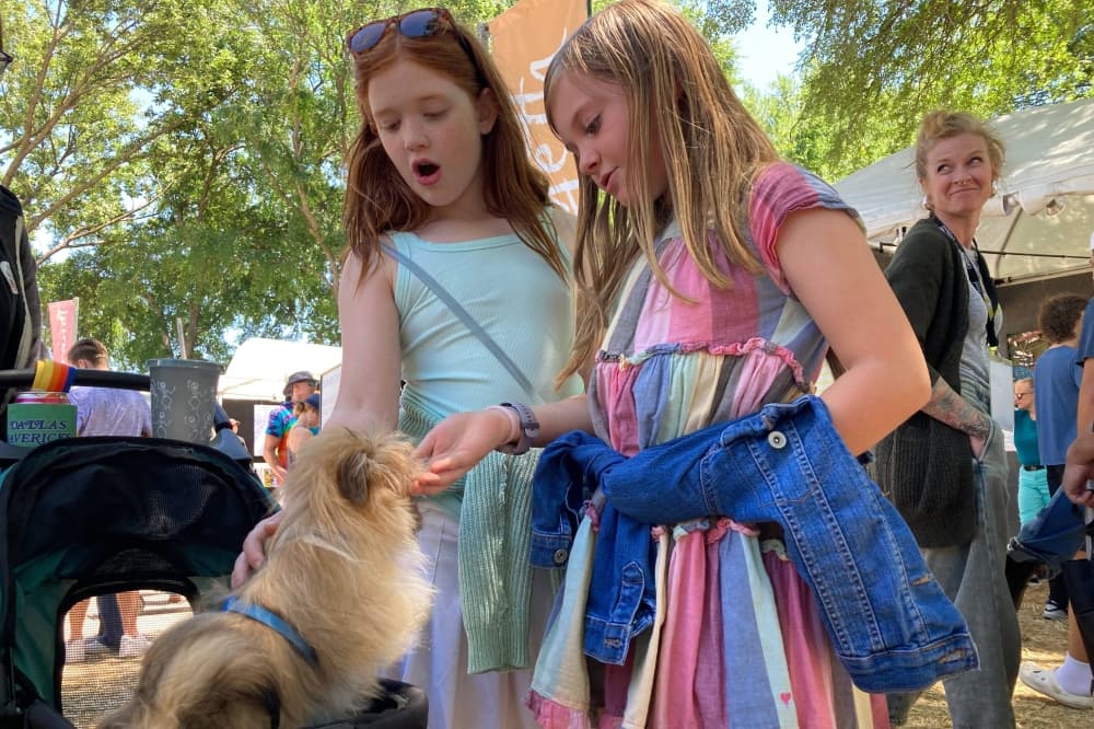 Two girls petting a dog