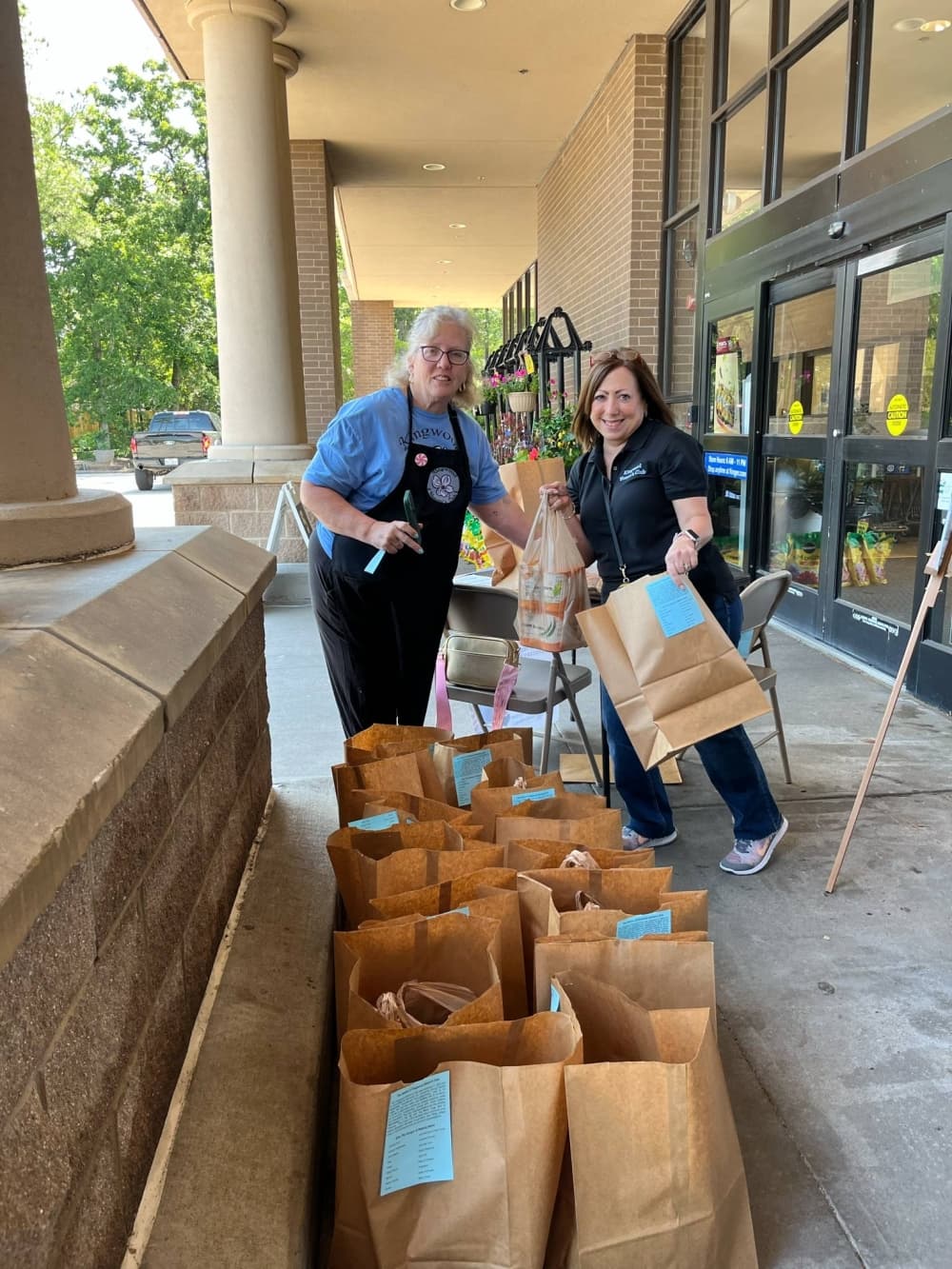 The Kingwood Women's Club food drive yielded 2.3 tons of donated food. From left, volunteers Nancy Rubiano and Sarina Novich helped sort food donations during the May 3 event. (Courtesy Kingwood Women's Club) 