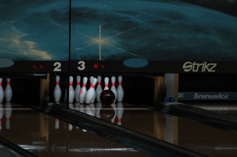 a bowling ball hits bowling pins