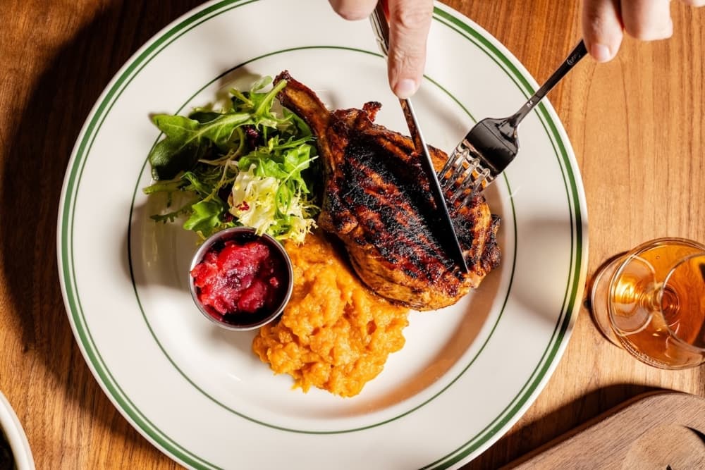 Pork chop being cut