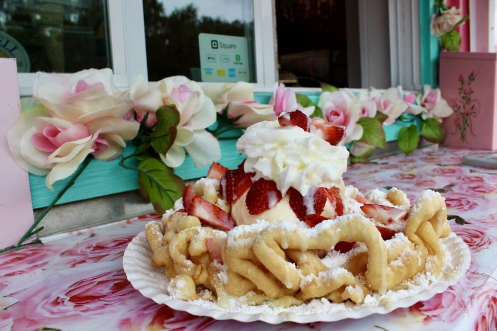 Funnel cake with whipped cream and strawberries 
