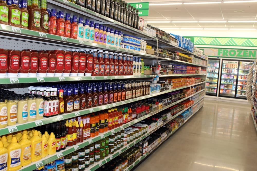 Groceries on shelves with $1.25 price labels. 