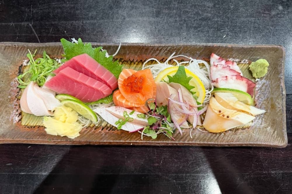Overview of various pieces of sashimi on a plate.