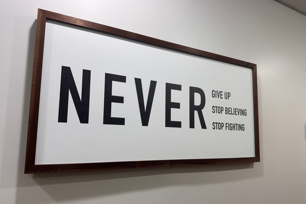 A sign inside the office that encourages patients to keep striving toward their goals.
