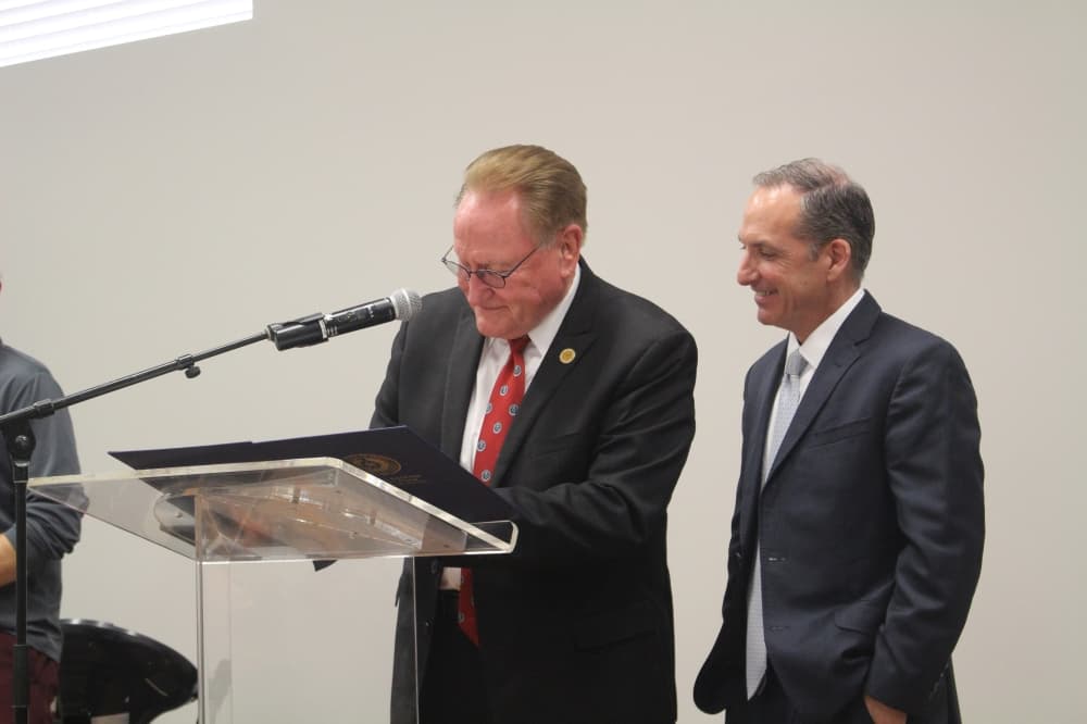 men at a podium