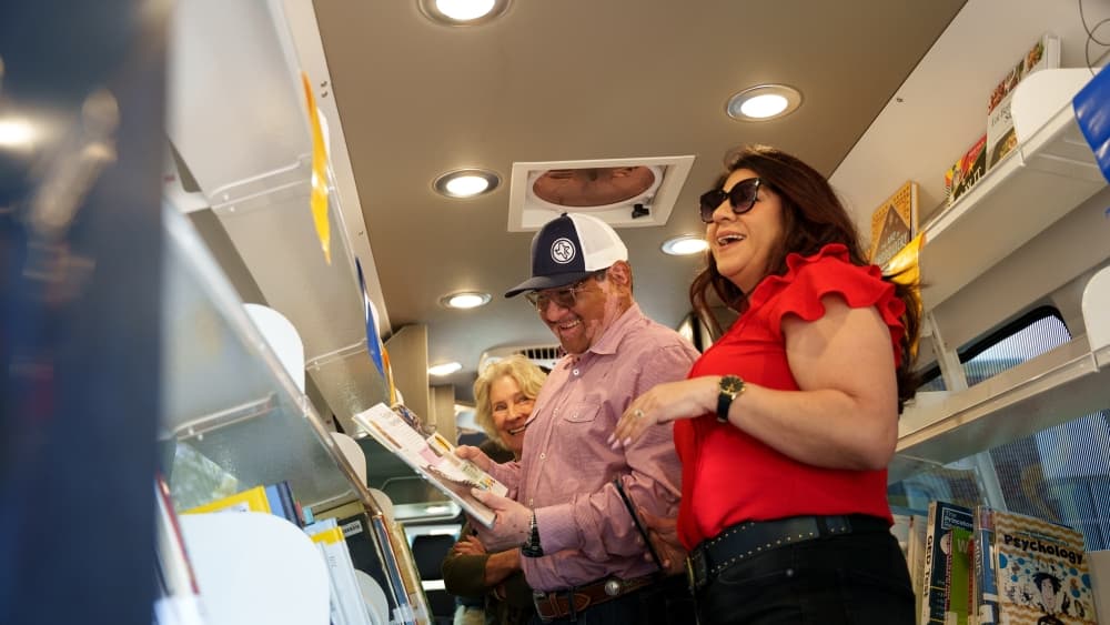 People looking at books within the mobile library