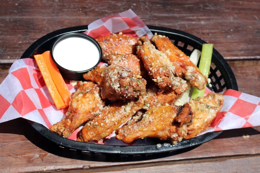 Basket of wings with side of ranch dressing, carrot and celery. 