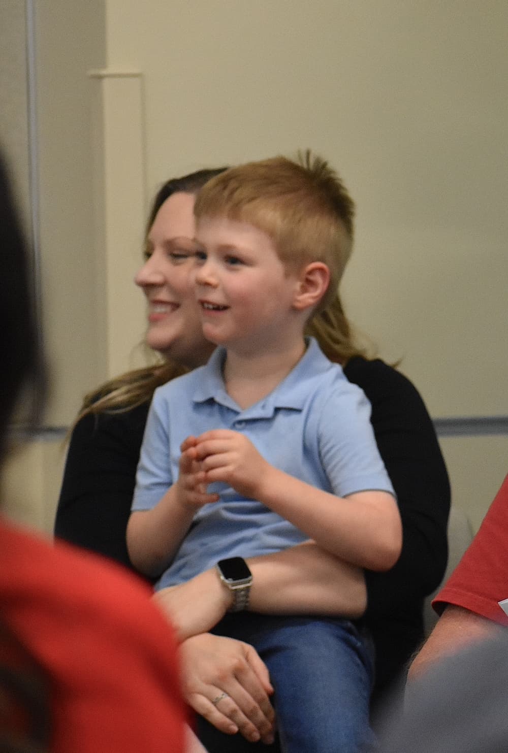 a seated woman holds a child