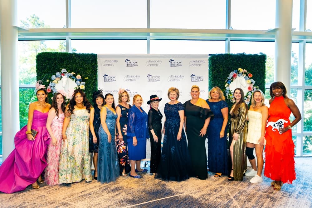 row of women in gowns