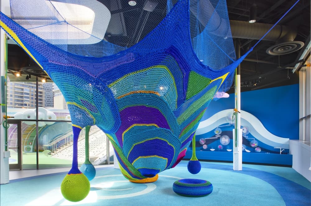 Artistic indoor playground apparatus featuring water theme color scheme. 