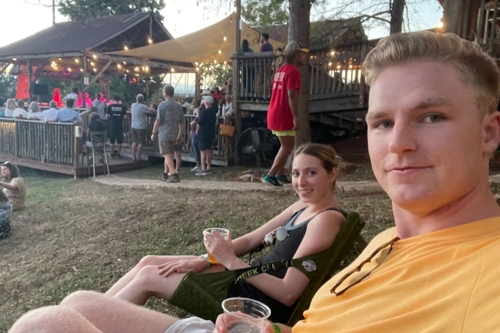 The couple pose for a photo