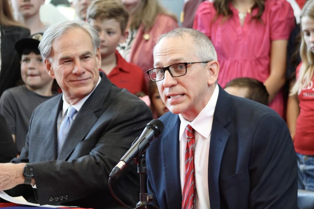 Salado ISD Superintendent Michael Novotny, right, speaks during a June 4 bill signing ceremony at Salado Middle School. (Hannah Norton/Community Impact)
