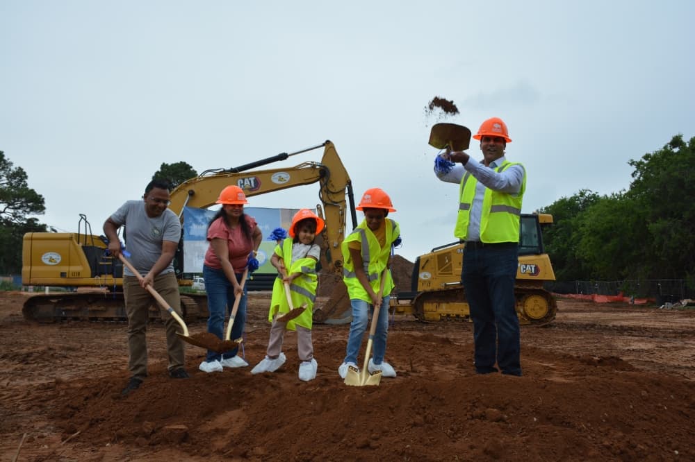 Family members of the Flower Mound Lightbridge Academy owners, including Renuka KP, second from left, and Vishal Gandhi, right, participated in the June 5 groundbreaking ceremony. 