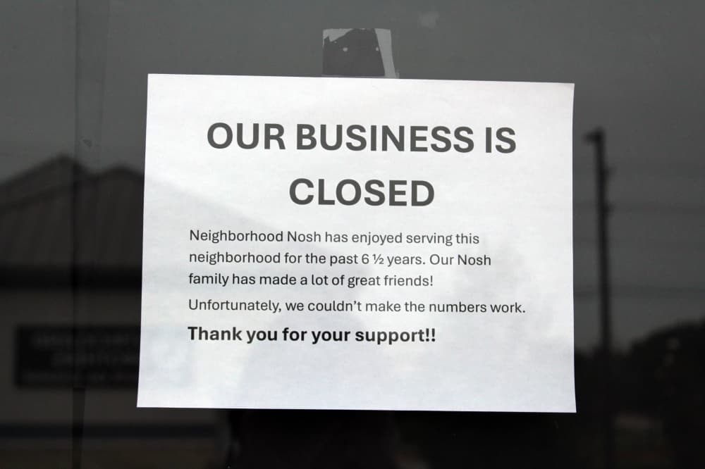 Paper sign in a window stating Our Business is Closed.